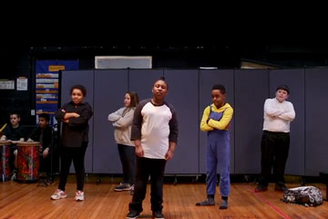 Five elementary students performing rap routine
