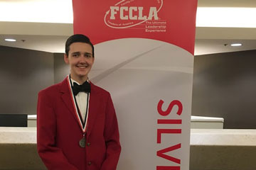 Student in front of FCCLA banner