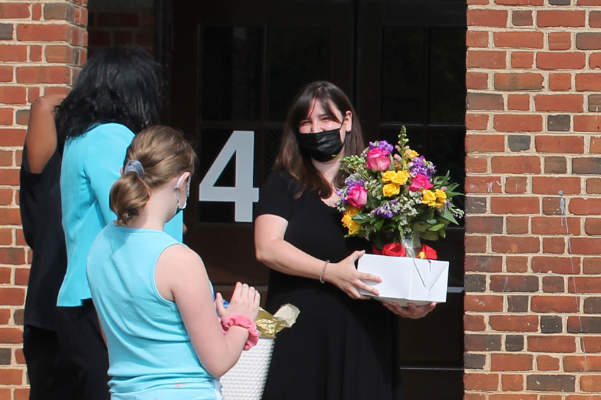 Dr. Edwards and students presenting Teacher of the Year to Rachel Parr outside T. C. Miller Elementary