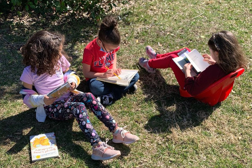 Girls outside reading books