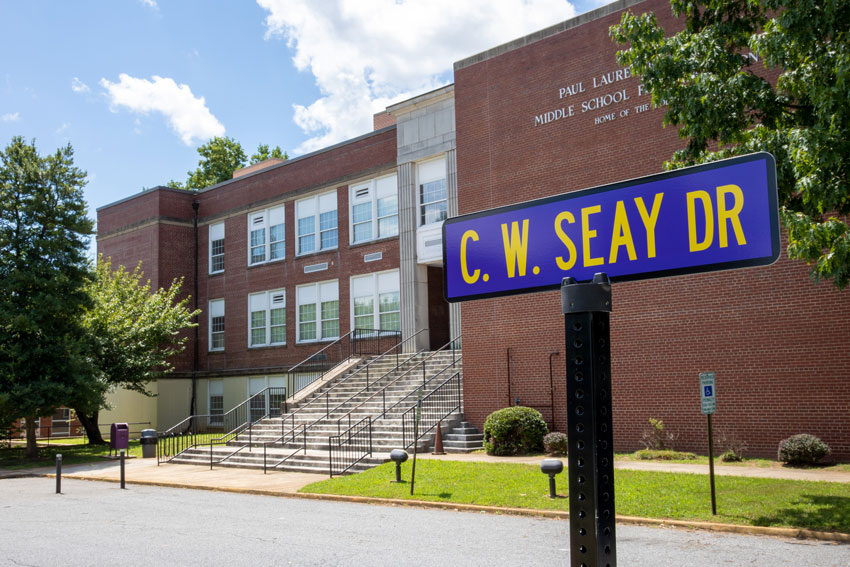 Street sign that reads "C. W. Seay Dr" in front of Dunbar Middle School for Innovation