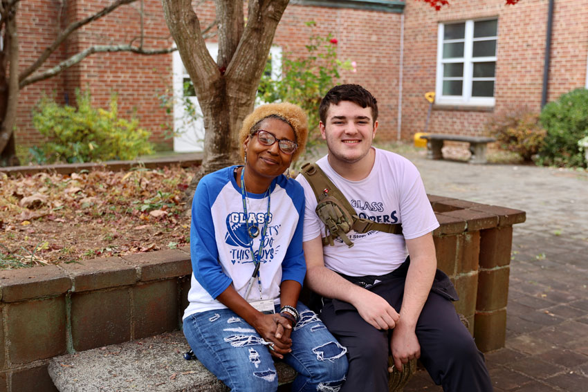 Gretta Ford with student in courtyard