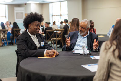 Student and adult at table during interview