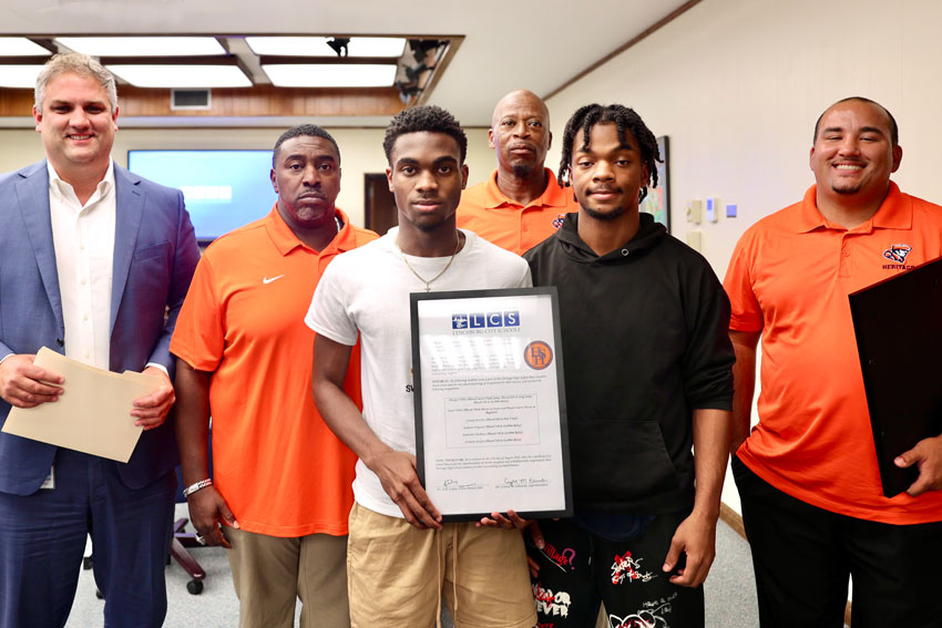 Dr. Wodicka with HHS Boys Track team representatives during School Board recognition