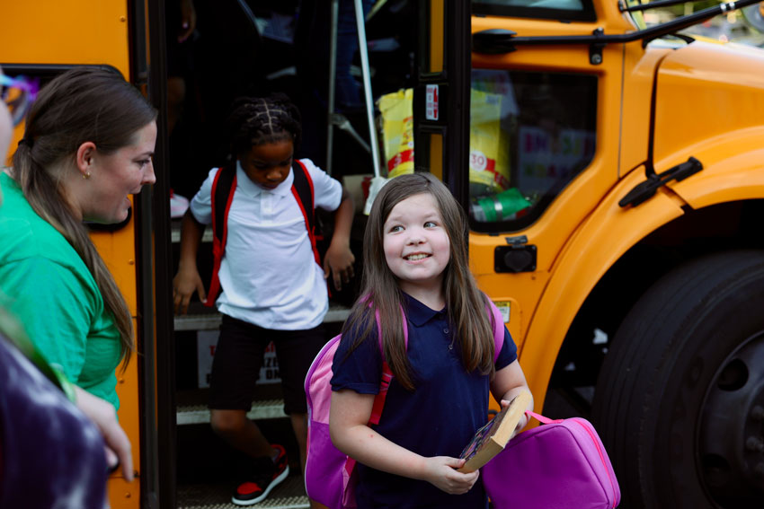 Students stepping off school bus