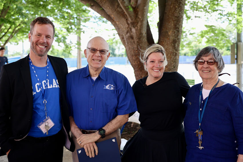 Rod Camden with administrators and school booster