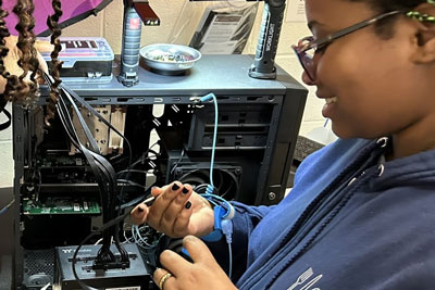Student wiring up computer power supply