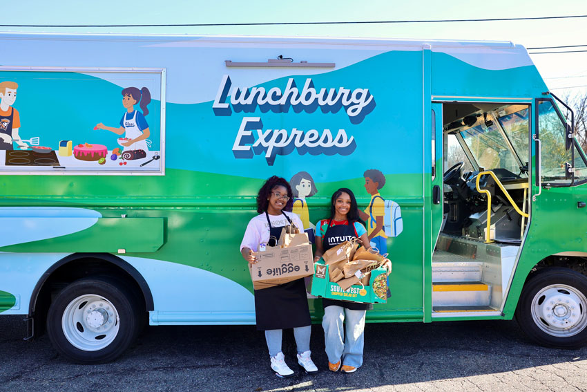 Two students in front of Lunchburg Express food truck