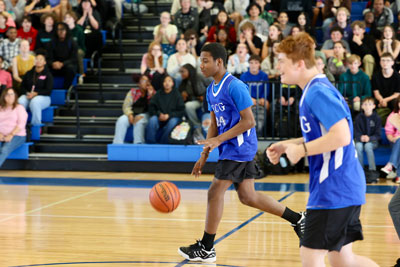 Basketball player dribbling ball down court during game