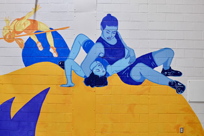 Mural of wrestlers and high jumper