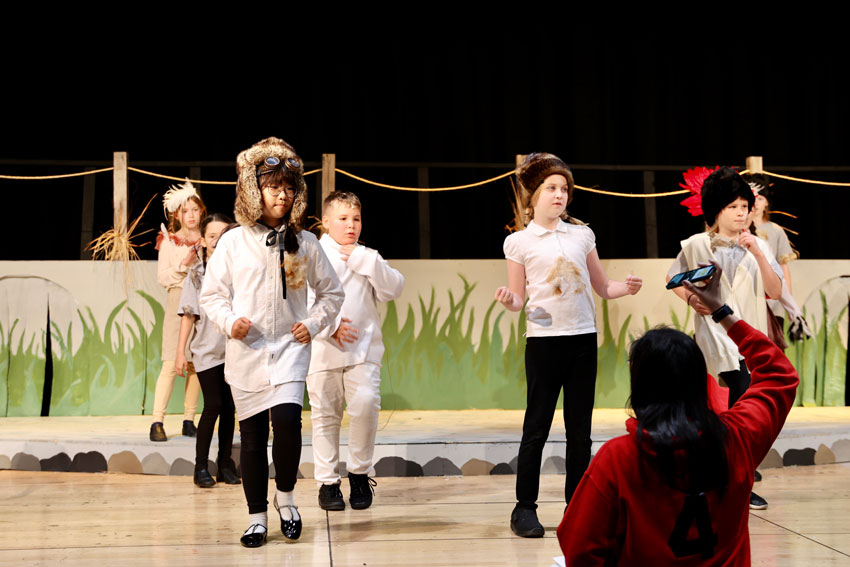 Elementary students rehearsing play on stage