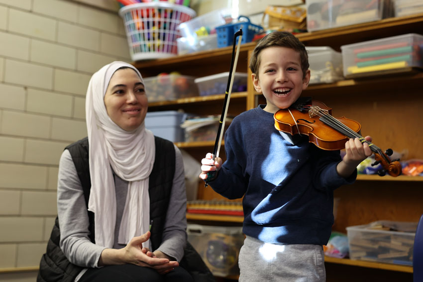 Parent with student during Suzuki strings class
