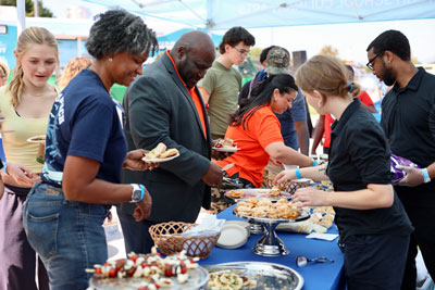 Event attendees being served food