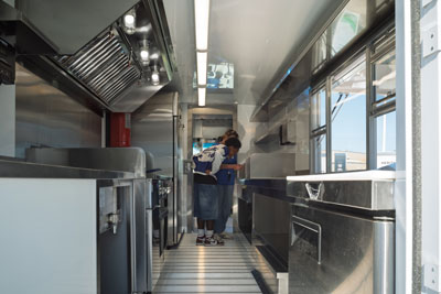 Two people exploring inside food truck