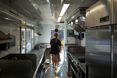 Two people touring inside in new food truck