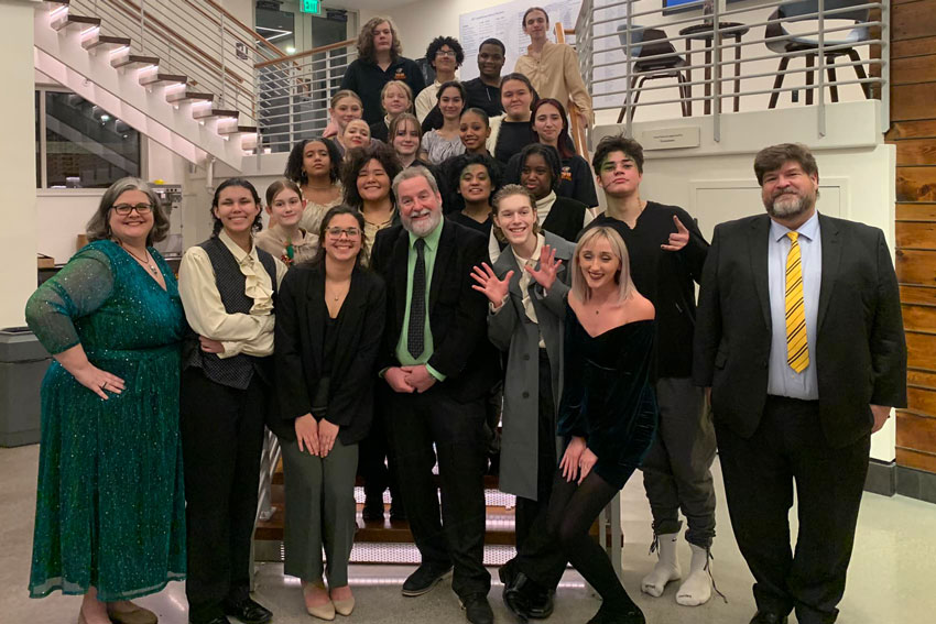 Theatre students and staff group photo on stairs at benefit event