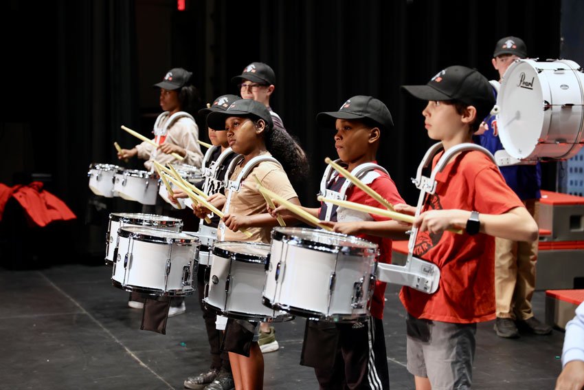 Elementary students playing drums