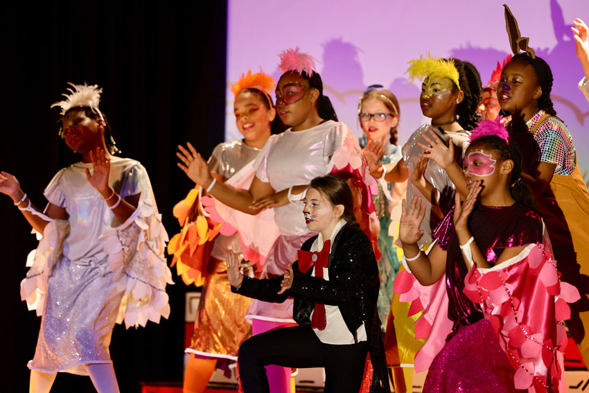 Elementary students performing musical number in costume