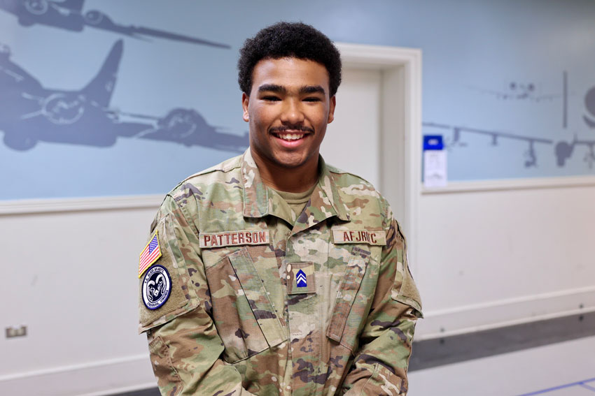 JROTC student in uniform standing in school hallway