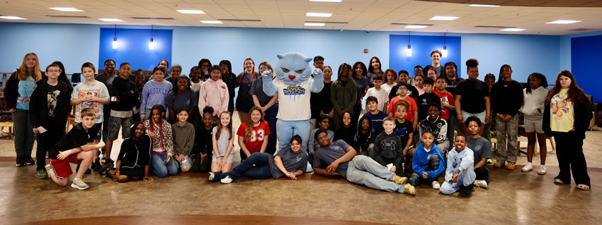 Large group of students poising for picture with CVCC Rivercats mascot