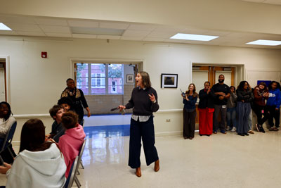 Teacher surprised by group of people in lecture hall