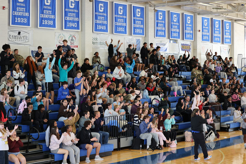 Crowd cheering during basketball game at E. C. Glass gym
