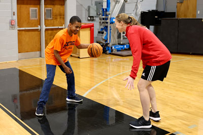 College basketball player working one-on-one during clinic