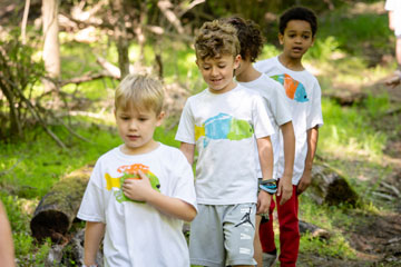 Elementary students hiking in woods