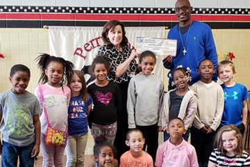 Kermit Waller presenting $3000 check to Perrymont principal and students