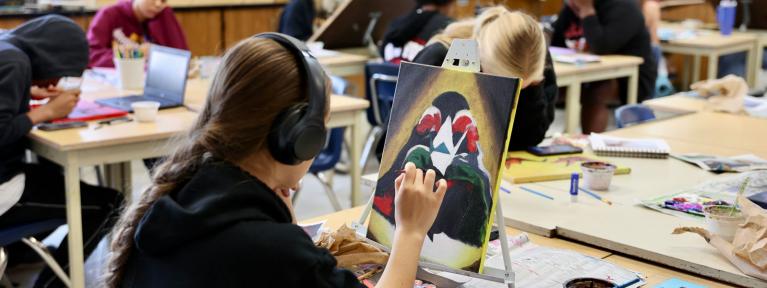 Student painting in art class