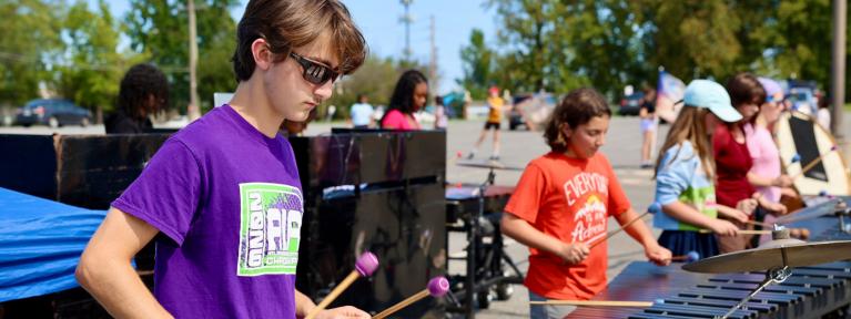 Marching band members practicing outside