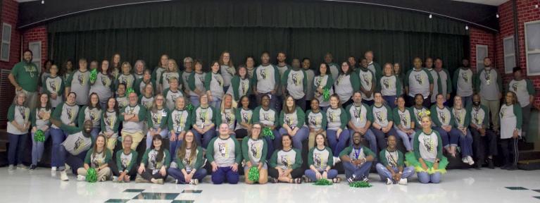 Group photo of school staff in matching shirts