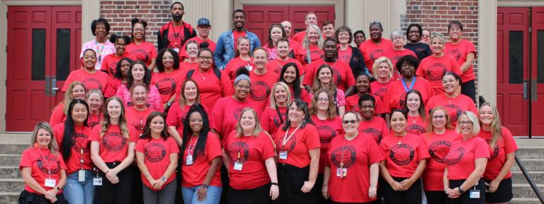 Staff group photo standing on steps