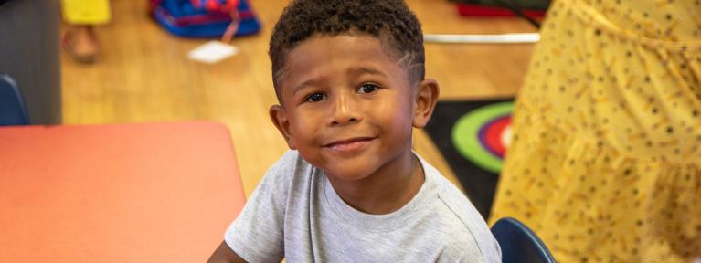Boy sitting at table in classroom