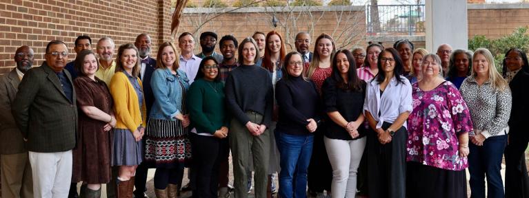 Group of teachers and Board members outside the School Administration Building