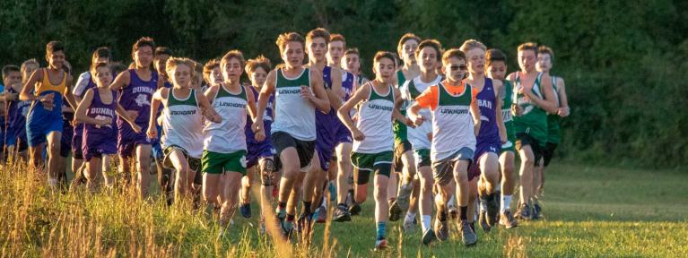 Boys cross country athletes running course
